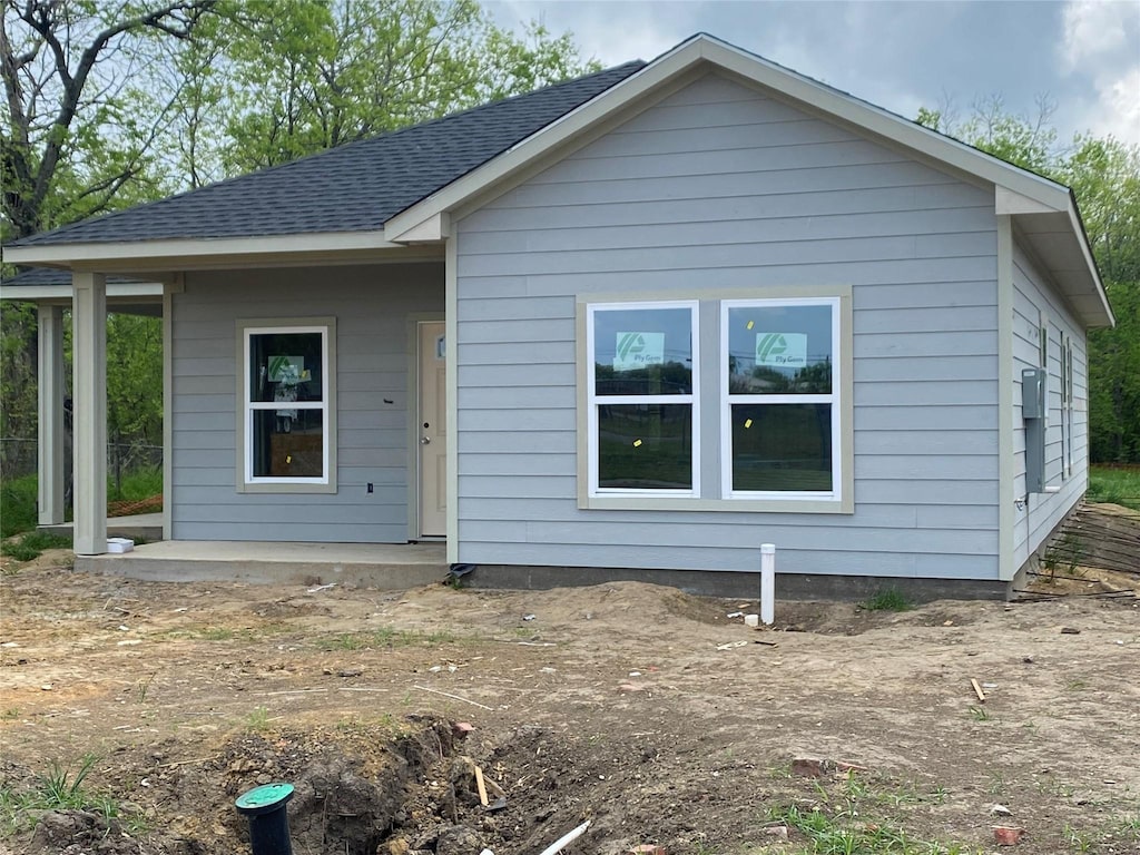 view of front of home featuring roof with shingles