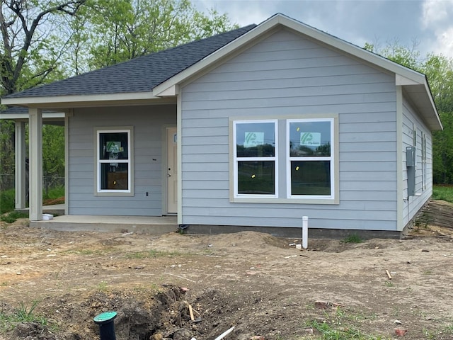 view of front of home featuring roof with shingles