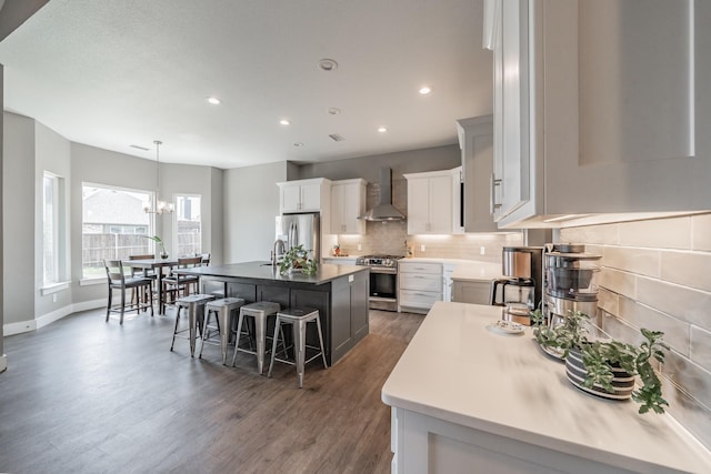 804 Shirley Jean Ln, Collinsville, TX 76233 - kitchen with wall chimney range hood, stainless steel appliances, decorative backsplash, dark wood finished floors, and a kitchen breakfast bar