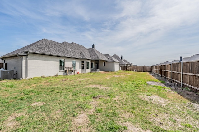 804 Shirley Jean Ln, Collinsville, TX 76233 - back of property featuring central AC unit, brick siding, and roof with shingles