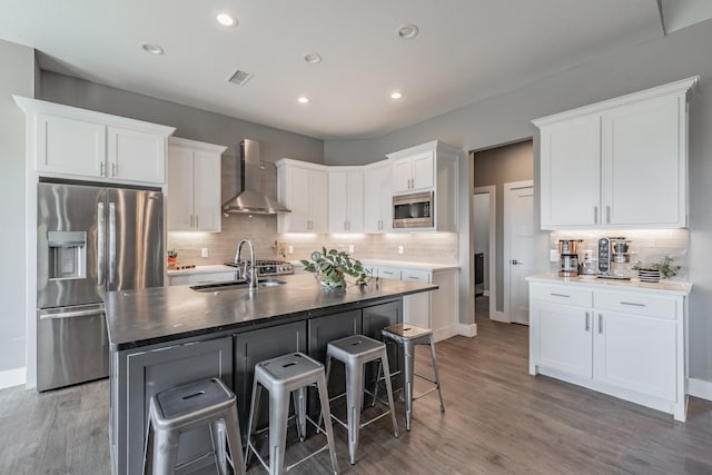 804 Shirley Jean Ln, Collinsville, TX 76233 - kitchen with appliances with stainless steel finishes, wall chimney range hood, a sink, backsplash, and white cabinetry