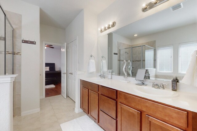 full bath with tile patterned floors, a sink, visible vents, a shower stall, and ensuite bath