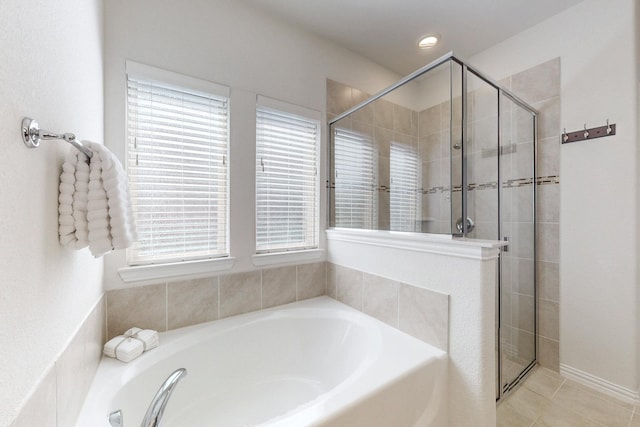 bathroom featuring a garden tub, tile patterned flooring, and a stall shower