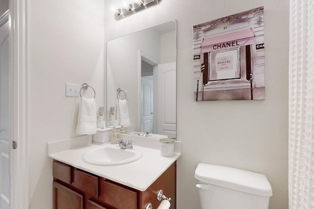 bathroom featuring toilet and vanity