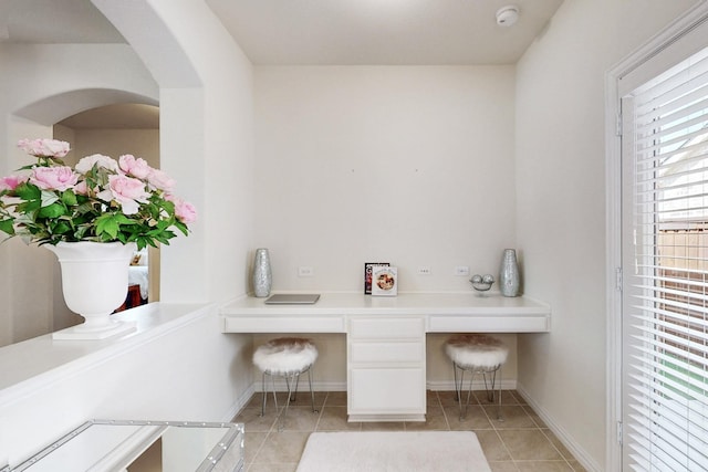 interior space with tile patterned floors and baseboards