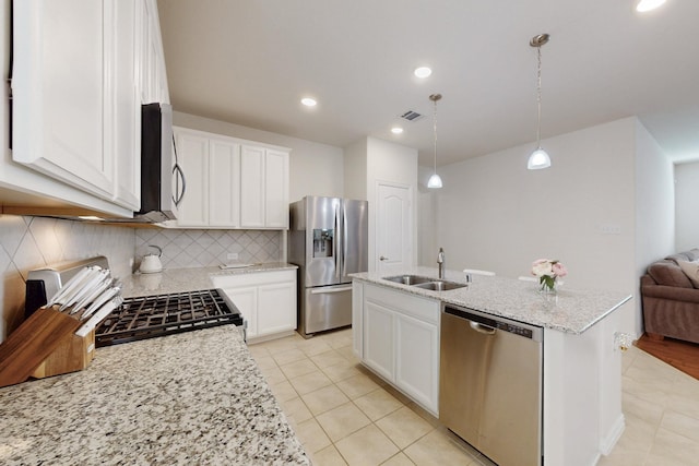 kitchen featuring a sink, light tile patterned floors, backsplash, appliances with stainless steel finishes, and visible vents