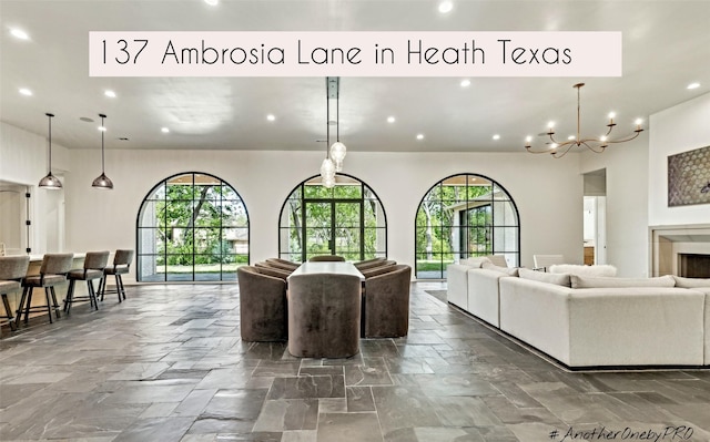 137 Ambrosia Ln, Heath, TX 75032 - living room with recessed lighting, a chandelier, and stone tile floors