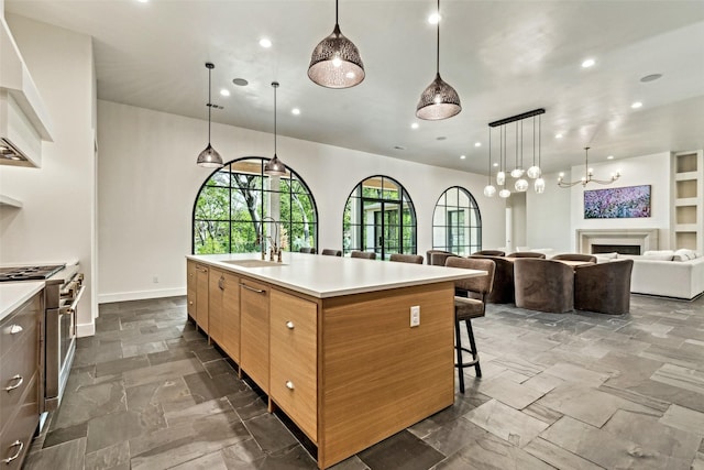 137 Ambrosia Ln, Heath, TX 75032 - kitchen featuring a sink, high end stove, plenty of natural light, recessed lighting, and light countertops