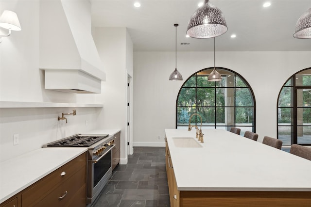 137 Ambrosia Ln, Heath, TX 75032 - kitchen featuring high end range, custom range hood, a sink, light countertops, and recessed lighting