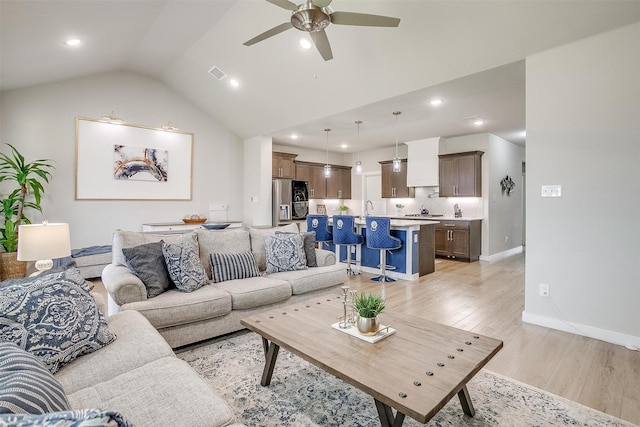 10600 Barrington Ln, Fort Worth, TX 76126 - living area with visible vents, baseboards, a ceiling fan, light wood-style flooring, and vaulted ceiling