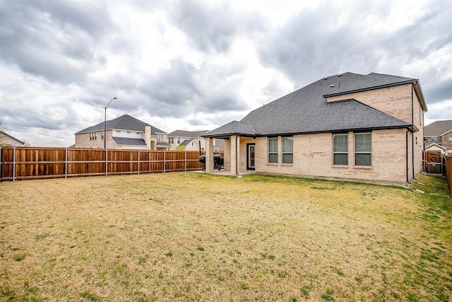 10600 Barrington Ln, Fort Worth, TX 76126 - rear view of property featuring brick siding, a fenced backyard, a patio area, and a shingled roof