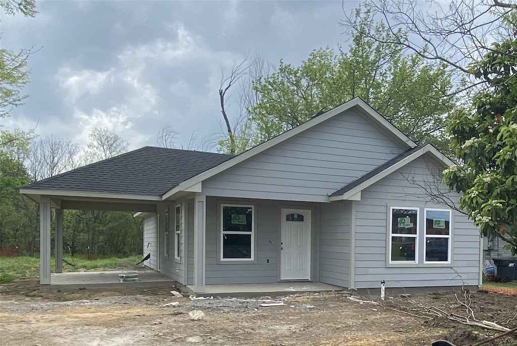 view of front of home featuring a shingled roof