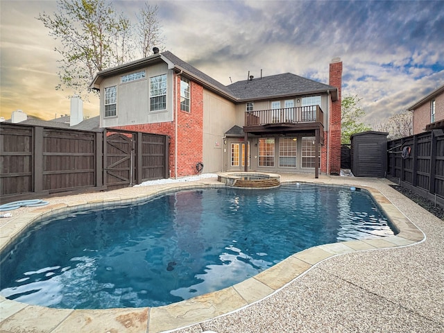 view of pool featuring a pool with connected hot tub and a fenced backyard