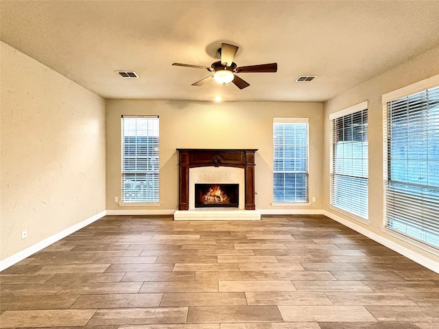 spare room with lofted ceiling, light wood finished floors, ornamental molding, a textured ceiling, and ceiling fan