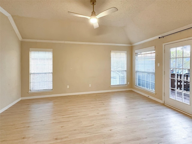 empty room with lofted ceiling, a ceiling fan, a textured ceiling, and visible vents
