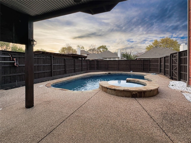 view of swimming pool with a fenced backyard, a patio, and a pool with connected hot tub