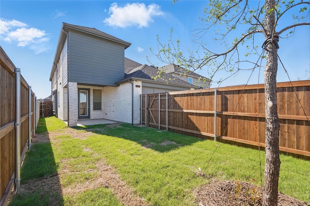 2836 Holland Ct, Celina, TX 75009 - back of property with a yard, a patio area, a fenced backyard, and brick siding