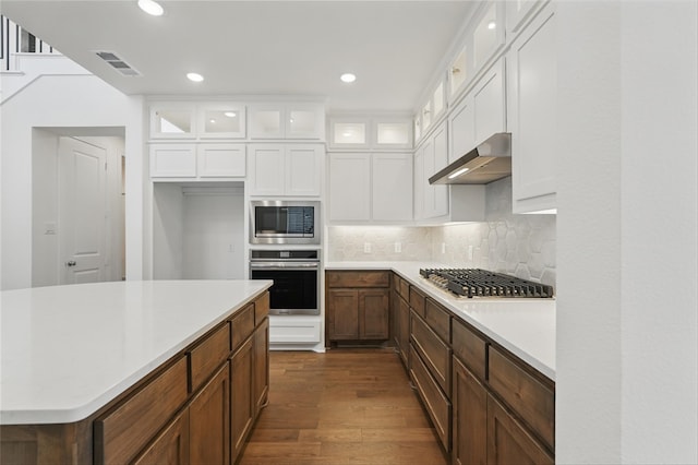 2836 Holland Ct, Celina, TX 75009 - kitchen with decorative backsplash, white cabinets, stainless steel appliances, light countertops, and dark wood-type flooring