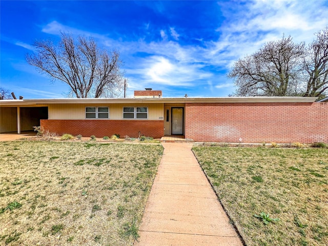 220 N 15th Ave, Munday, TX 76371 - single story home featuring brick siding, a front yard, and a chimney
