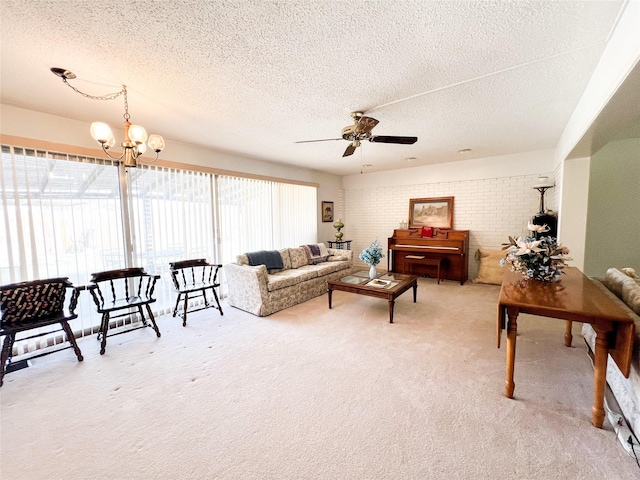 220 N 15th Ave, Munday, TX 76371 - living area with a textured ceiling, brick wall, ceiling fan with notable chandelier, and light carpet