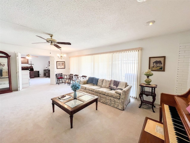 220 N 15th Ave, Munday, TX 76371 - living room with light carpet, ceiling fan with notable chandelier, and a textured ceiling