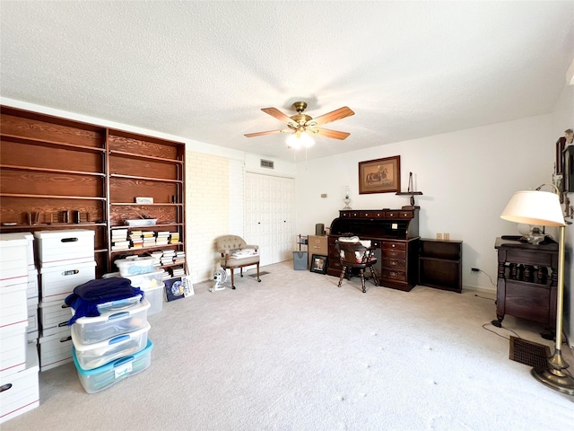 220 N 15th Ave, Munday, TX 76371 - carpeted office space with visible vents, ceiling fan, and a textured ceiling