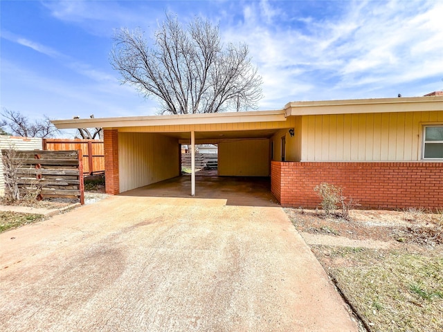 220 N 15th Ave, Munday, TX 76371 - view of car parking with an attached carport, fence, and concrete driveway