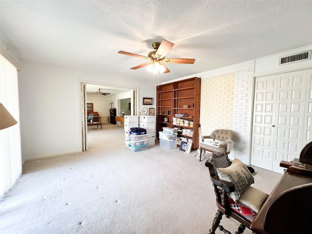 220 N 15th Ave, Munday, TX 76371 - interior space featuring a textured ceiling, visible vents, carpet, and a ceiling fan