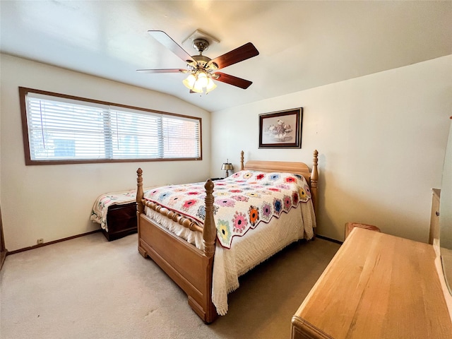 220 N 15th Ave, Munday, TX 76371 - bedroom featuring light carpet, baseboards, lofted ceiling, and ceiling fan