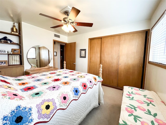 220 N 15th Ave, Munday, TX 76371 - bedroom with a closet, ceiling fan, visible vents, and light colored carpet