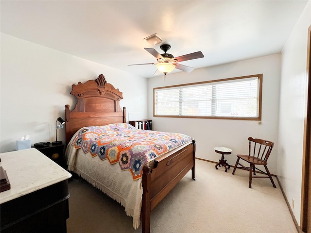 220 N 15th Ave, Munday, TX 76371 - bedroom with light carpet, baseboards, and a ceiling fan