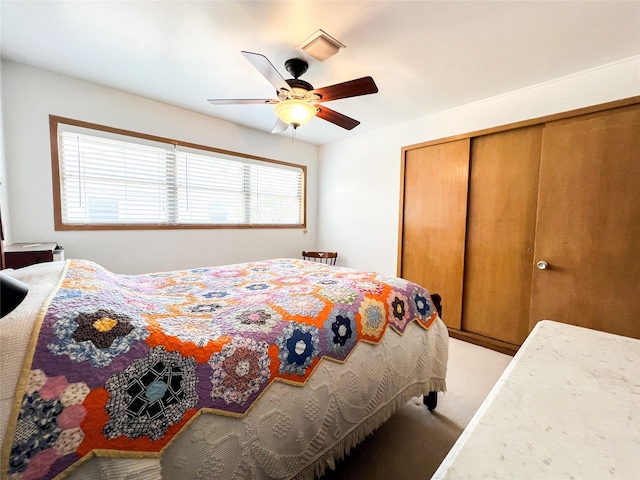 220 N 15th Ave, Munday, TX 76371 - bedroom with a ceiling fan, a closet, and light colored carpet