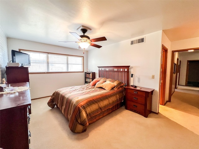 220 N 15th Ave, Munday, TX 76371 - bedroom with baseboards, ceiling fan, visible vents, and light carpet