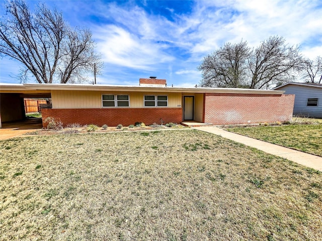 220 N 15th Ave, Munday, TX 76371 - single story home featuring brick siding, a chimney, a front lawn, and a carport