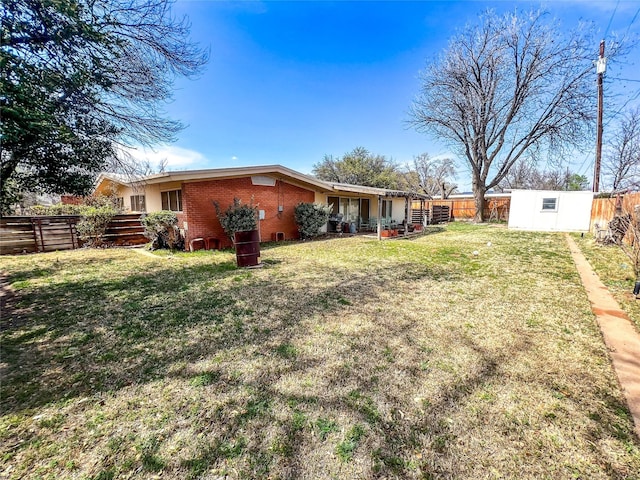 220 N 15th Ave, Munday, TX 76371 - view of yard with a fenced backyard and an outbuilding