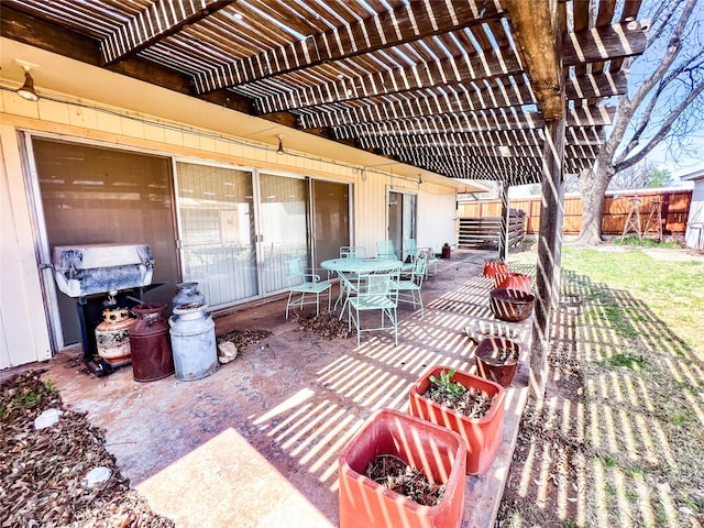 220 N 15th Ave, Munday, TX 76371 - view of patio with fence, outdoor dining space, and a pergola
