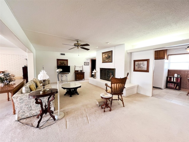 220 N 15th Ave, Munday, TX 76371 - living room featuring a ceiling fan, light carpet, and a fireplace
