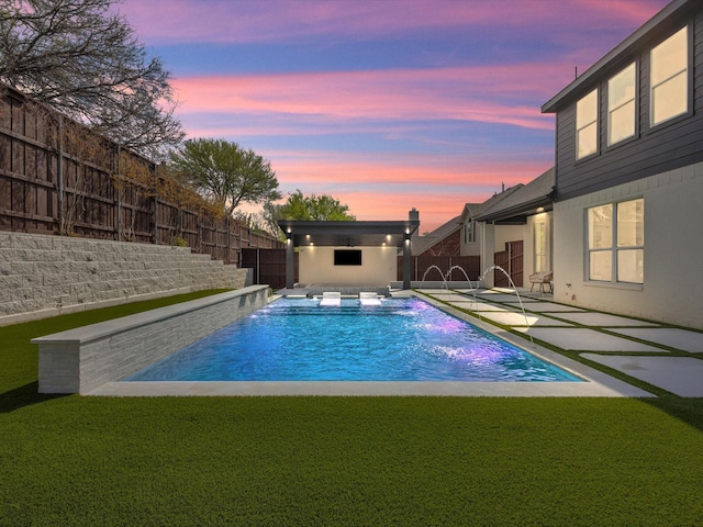 pool at dusk with a patio, a fenced backyard, a fenced in pool, and a lawn