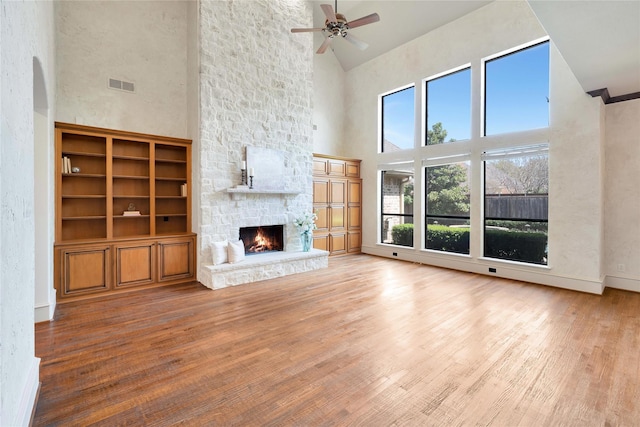 5460 Stone Canyon Dr, Frisco, TX 75034 - unfurnished living room featuring visible vents, wood finished floors, a towering ceiling, and ceiling fan
