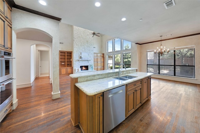 5460 Stone Canyon Dr, Frisco, TX 75034 - kitchen with a sink, ceiling fan with notable chandelier, visible vents, dark wood-style flooring, and appliances with stainless steel finishes
