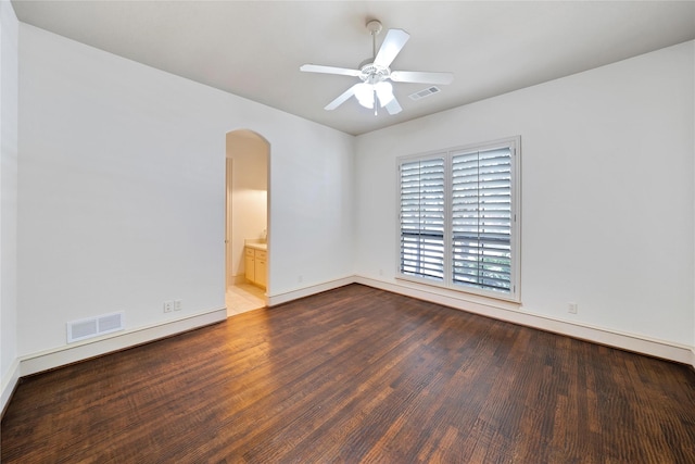 5460 Stone Canyon Dr, Frisco, TX 75034 - spare room with arched walkways, wood finished floors, baseboards, and a ceiling fan