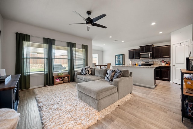 living room featuring light wood-style floors, recessed lighting, and a ceiling fan