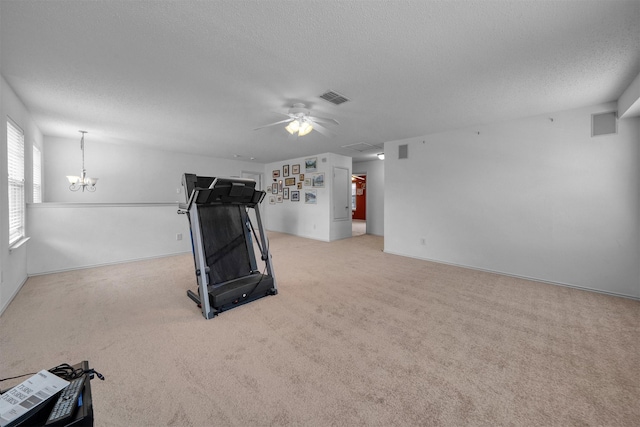600 Carol Way, Euless, TX 76039 - workout room featuring a textured ceiling, ceiling fan, a chandelier, and light carpet
