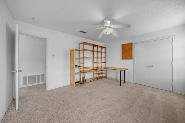 600 Carol Way, Euless, TX 76039 - carpeted bedroom with a textured ceiling, ceiling fan, and a closet