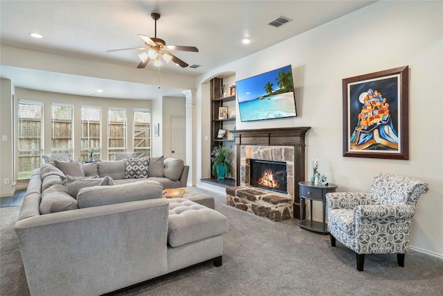 5218 Pueblo Ln, Frisco, TX 75034 - living room with carpet flooring, a fireplace, built in shelves, ceiling fan, and decorative columns