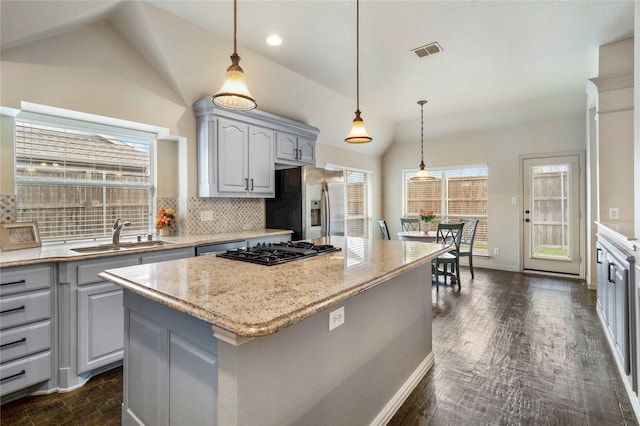 5218 Pueblo Ln, Frisco, TX 75034 - kitchen with a sink, vaulted ceiling, stainless steel refrigerator with ice dispenser, black gas stovetop, and tasteful backsplash