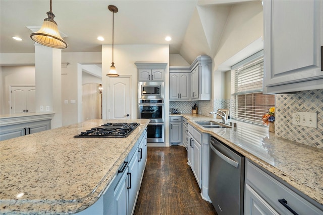 5218 Pueblo Ln, Frisco, TX 75034 - kitchen featuring stainless steel appliances, a sink, gray cabinetry, dark wood finished floors, and light stone countertops