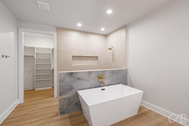 6817 Beals Creek Dr, Abilene, TX 79606 - bathroom with baseboards, recessed lighting, a freestanding bath, and wood finished floors