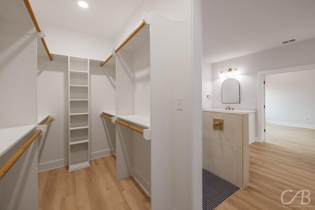 6817 Beals Creek Dr, Abilene, TX 79606 - walk in closet with light wood finished floors and visible vents