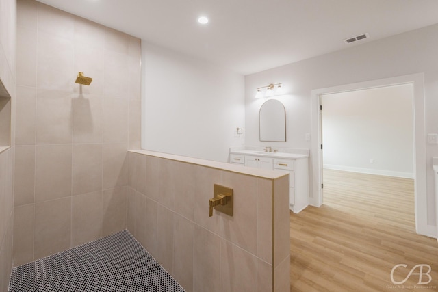 6817 Beals Creek Dr, Abilene, TX 79606 - full bath featuring tiled shower, recessed lighting, a sink, and wood finished floors